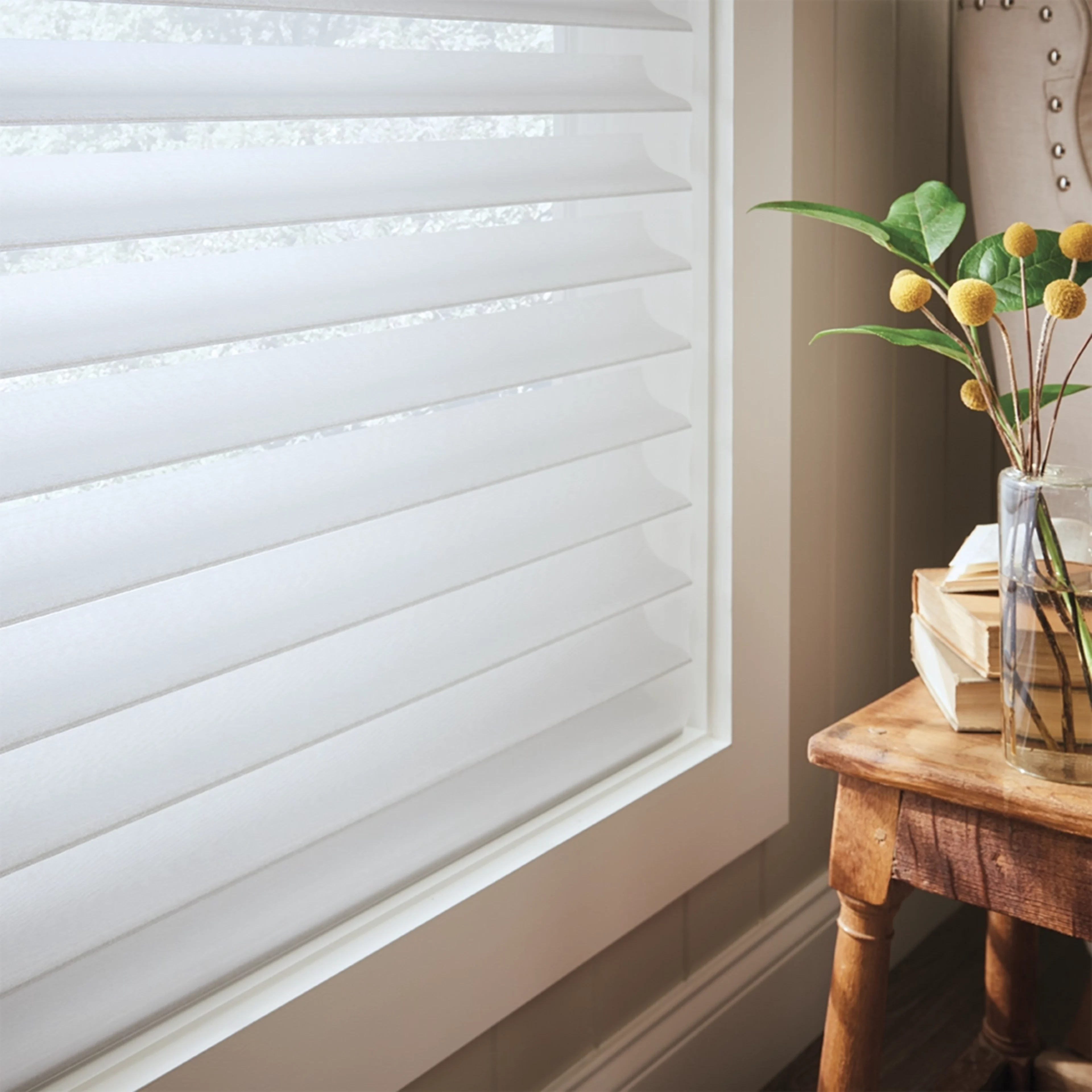 Close up of white fabric blinds in a bedroom window.