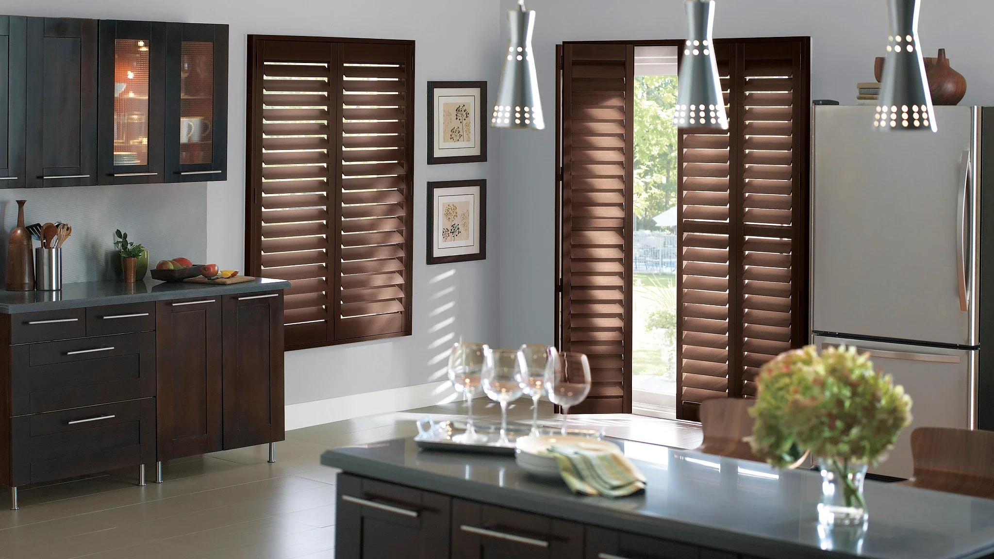 Wood window shutters in kitchen with Bi-fold track system on patio doors.