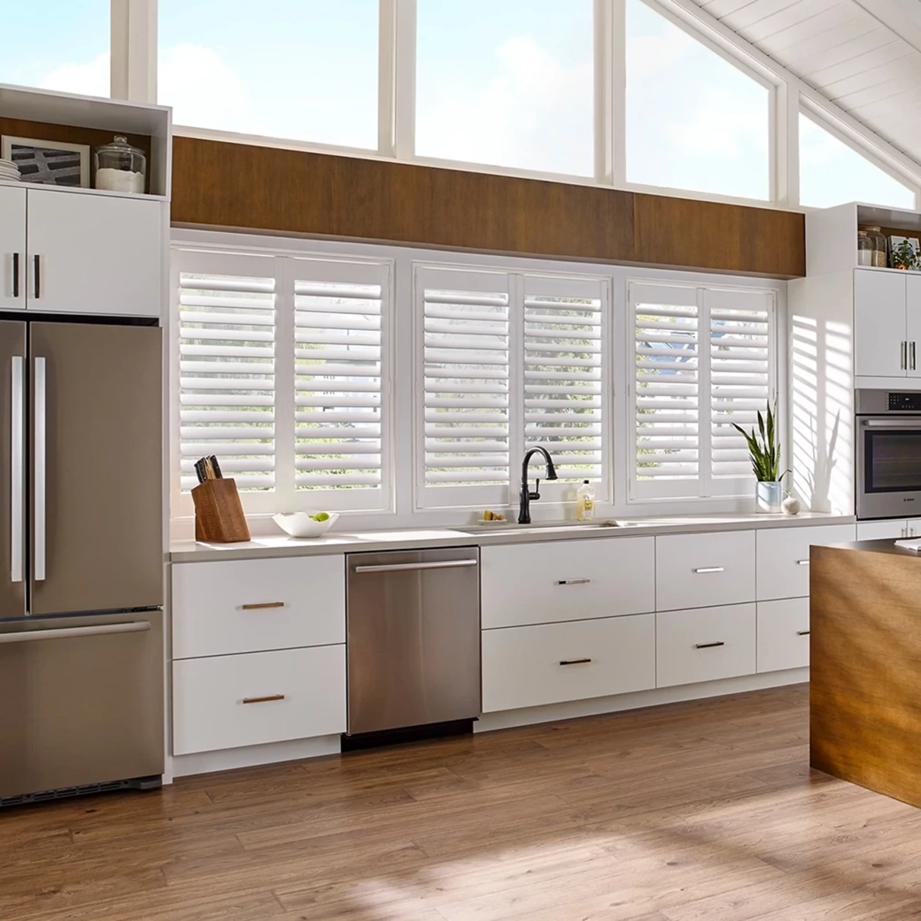 Large bright kitchen featuring custom window shutters.