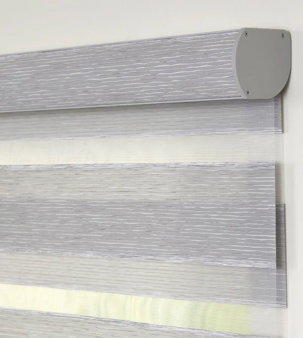 Banded shade cassette headrail with a gray fabric insert.