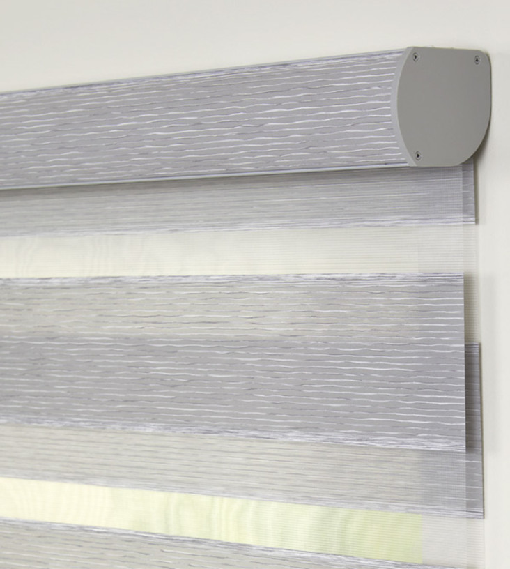 Banded shade cassette headrail with a gray fabric insert.
