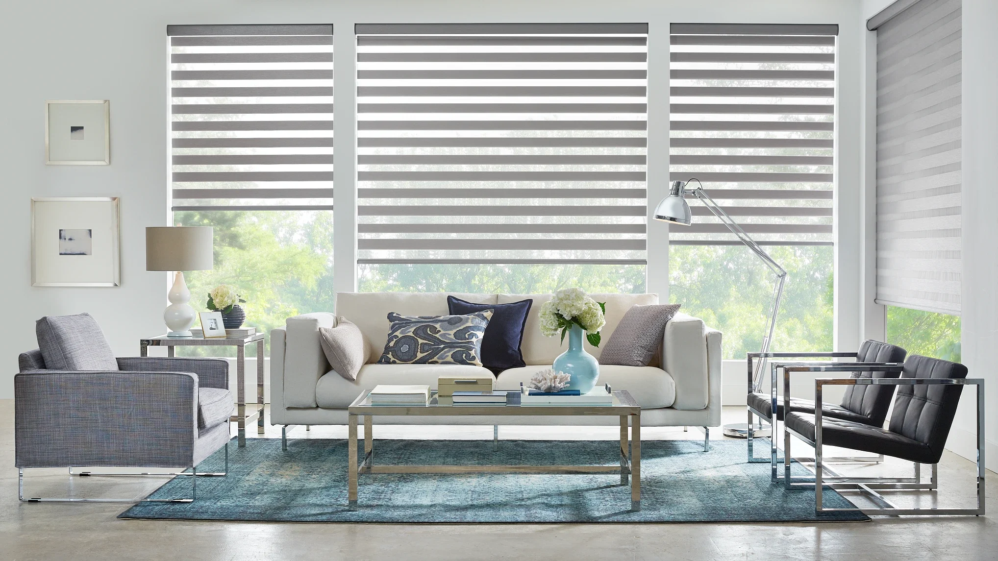 Gray motorized banded shades in a modern living room.