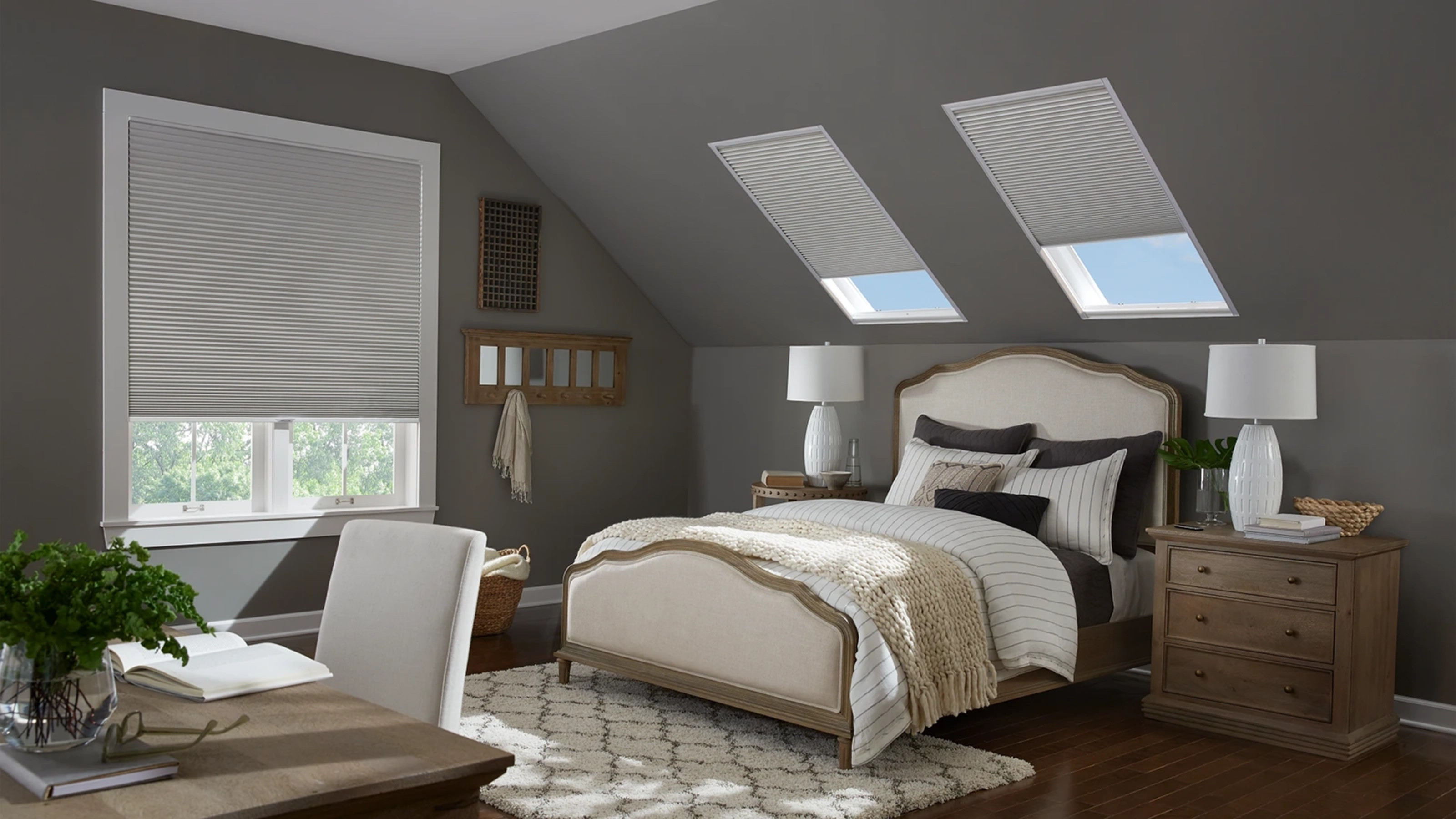 Honeycomb skylight shades in a cozy bedroom.