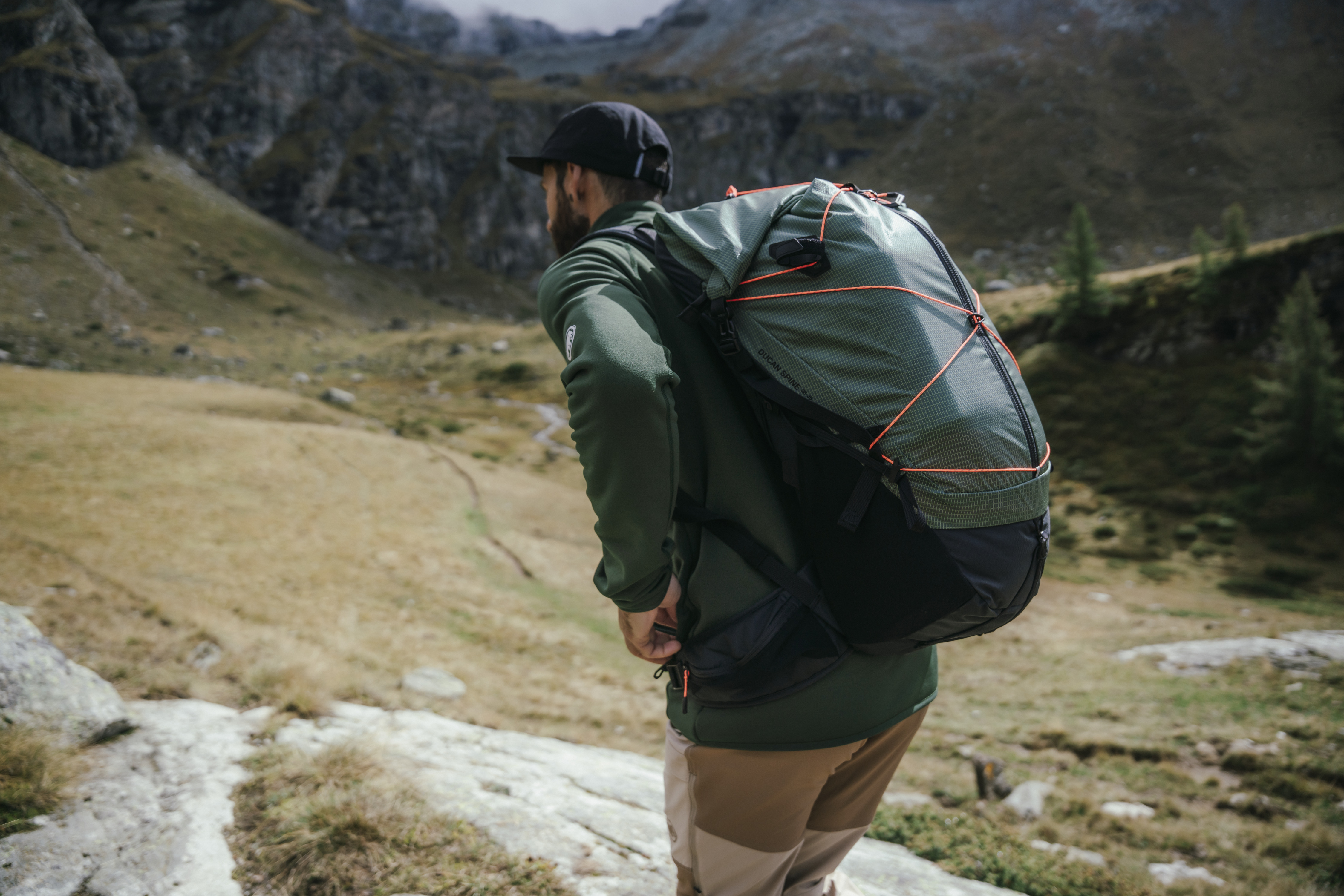 Hiker wearing Mammut gear in scenic alpine environment demonstrating real-world performance