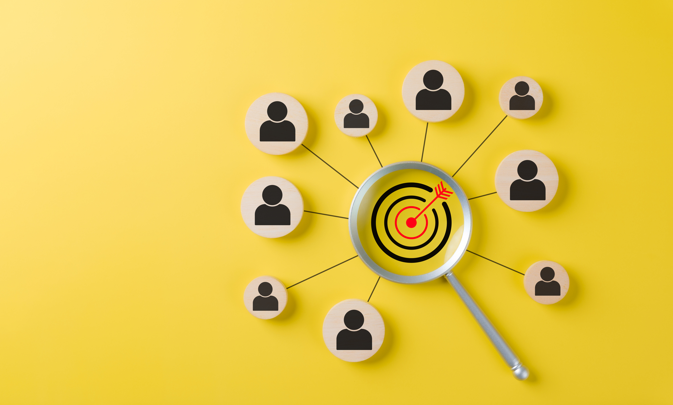 Magnifying glass over a target connected to user icons