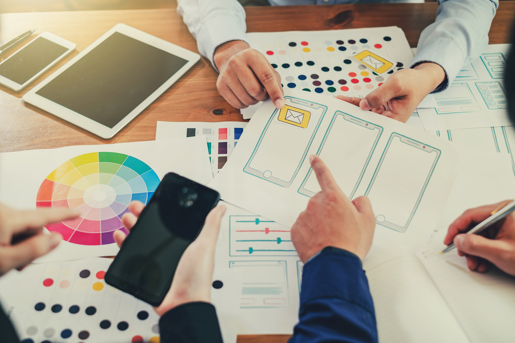 Web Designers work together on ux for an app design 