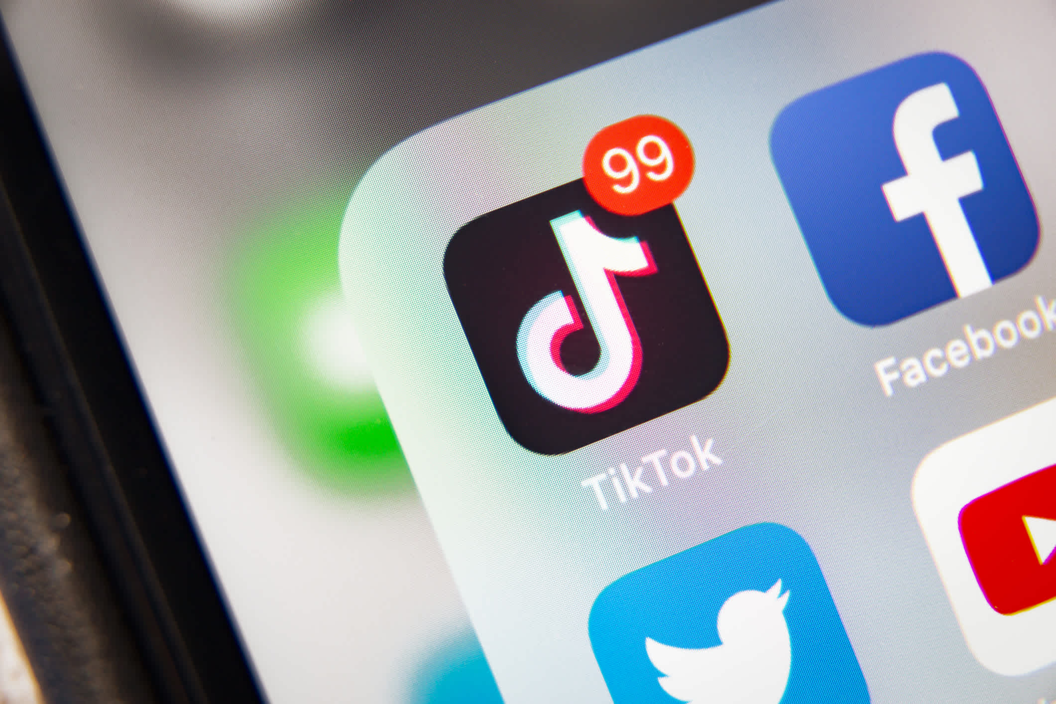 TikTok and Facebook application on screen Apple iPhone XR. | Watermark