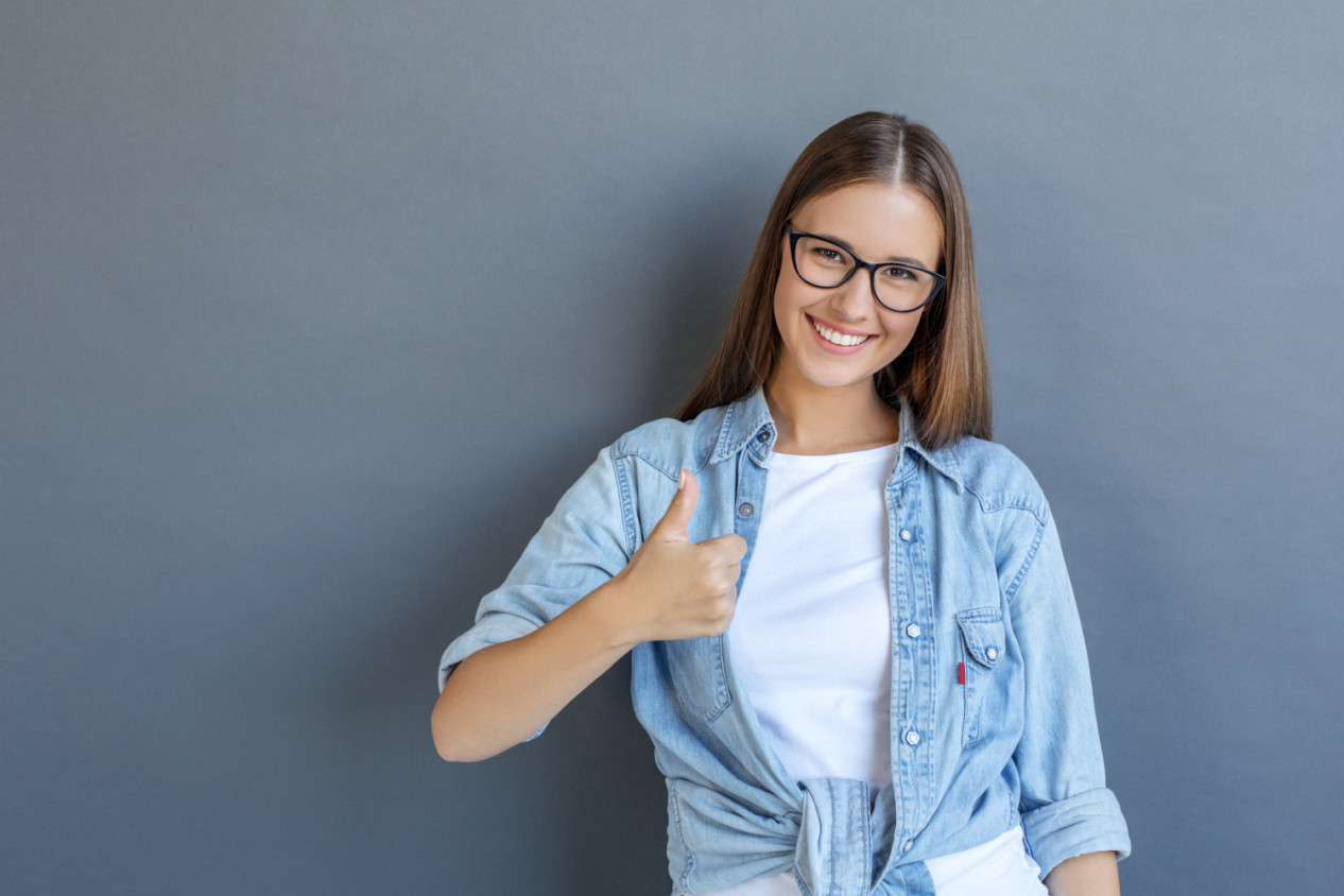 Young person free style isolated on grey wearing eyeglasses