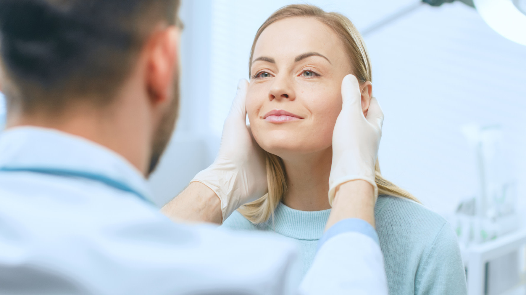 Cosmetic Surgeon Examines Beautiful Woman's Face