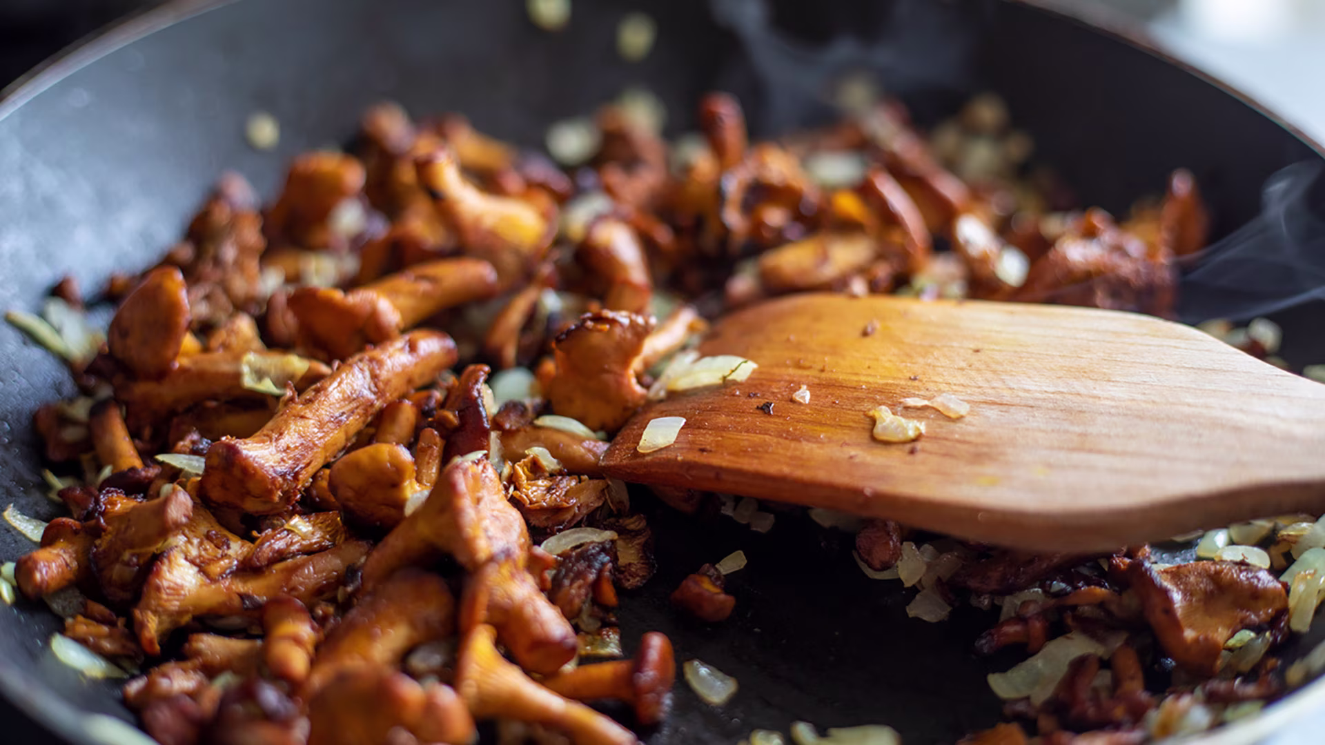 Gebratene Pilze mit Zwiebeln in einer Pfanne