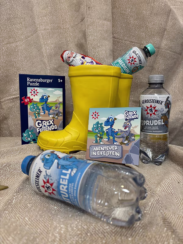 Paket mit Dino-Puzzle, Mineralwasser, Mini-Buch und Schoko-Nikolaus