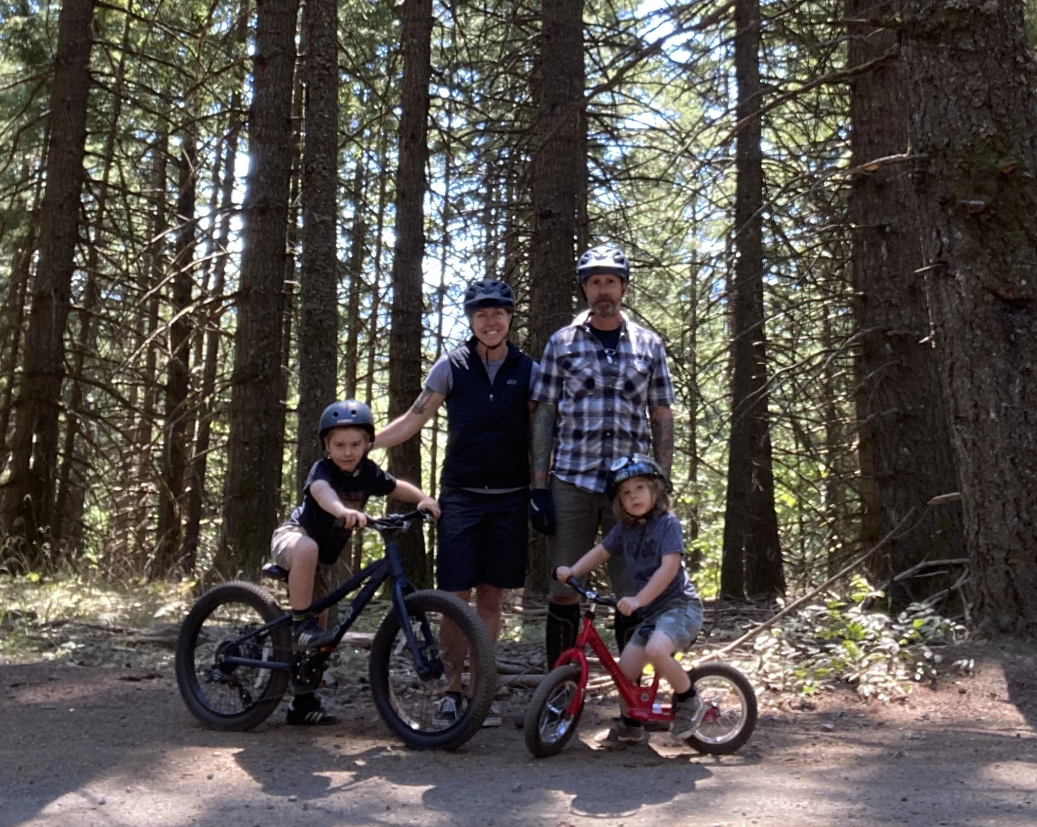 family biking together in the woods