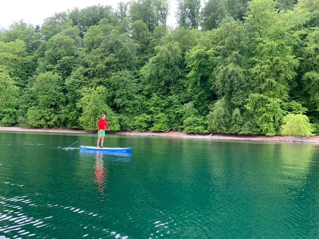 paddle boarding in green-blue water