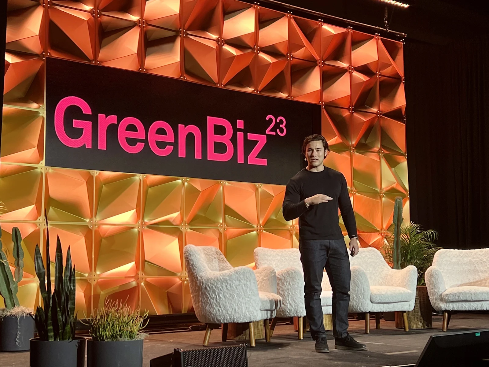 Persefoni's CEO Kentaro Kawamori standing on stage at the GreenBiz 2023 conference.