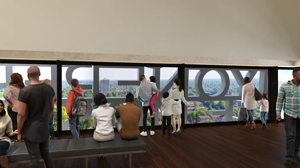 A digital rendering of the Sky Room at the Obama Presidential Center, showing people looking out a long window with large letters on the other side.