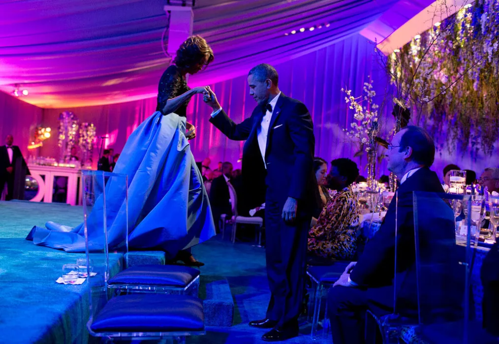 The President helps the First Lady off the stage
