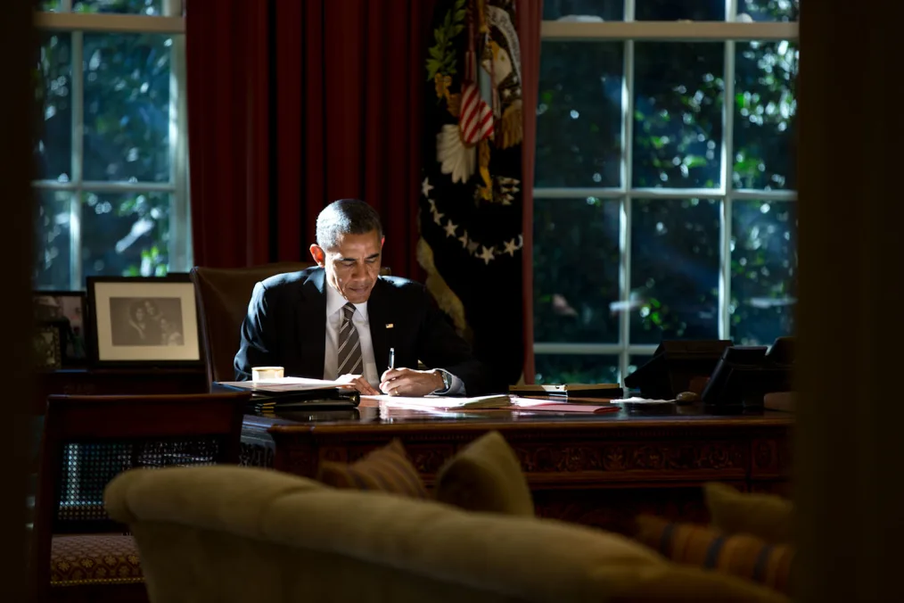 President Obama works at the Resolute Desk in the Oval Office