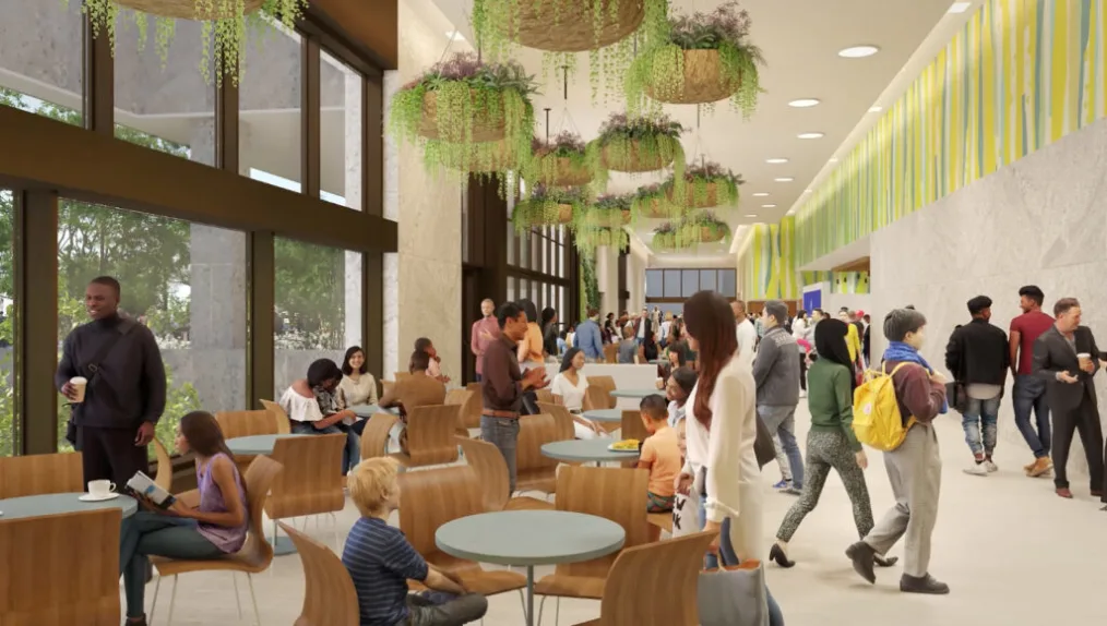 A rendering of the Winter Garden at the Obama Presidential Center, showing a group of people gathered around circular tables, with greenery hanging from the ceiling.
