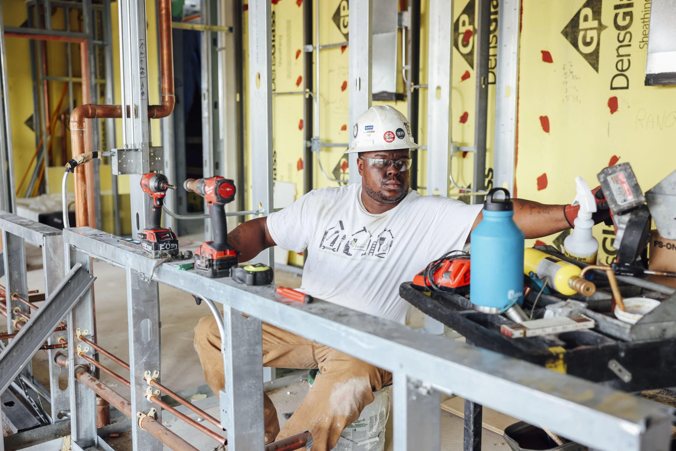 A man in a hardhat working at a construction site