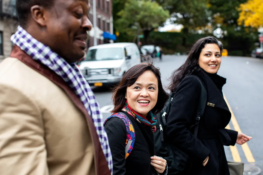 Hong Hoang smiles at a man as they walk down the sidewalk together.