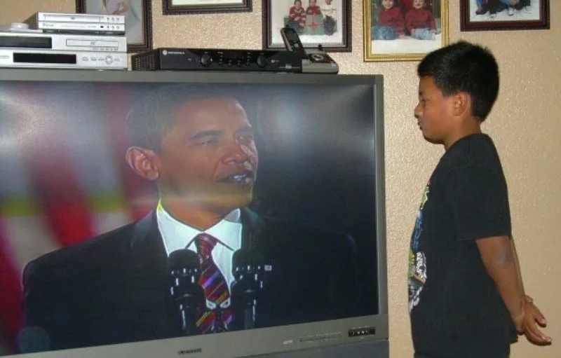 Young Boy watching Obama on television