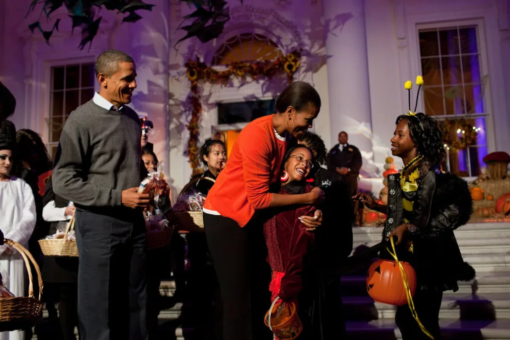 President Barack Obama and First Lady Michelle Obama hand out Halloween treats