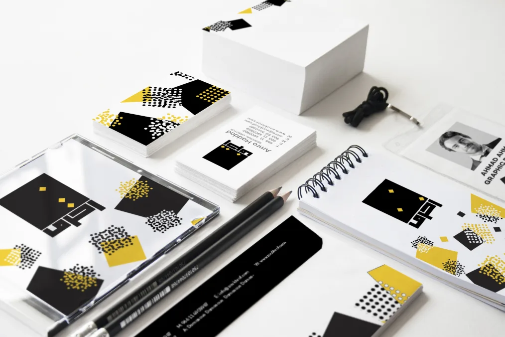 Printed business cards, notepads, and pencils.