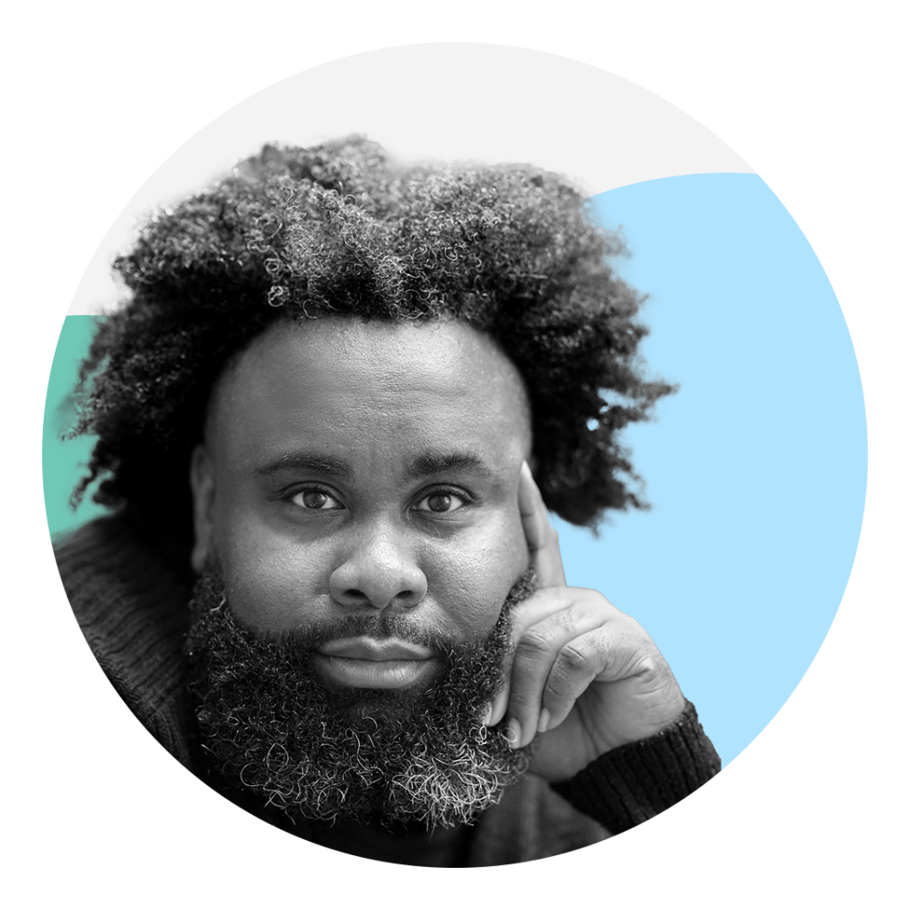 A black-and-white headshot of a Black man staring into the camera with his head resting against his hand and index finger. He has dark, curly hair and a long beard with some lighter strands. Behind him are three graphic circles: one light blue, one teal and one white.