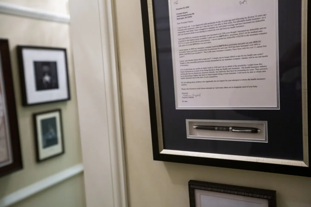 A letter from Natoma Canfield, a woman from Ohio that President Barack Obama met who didn’t have health insurance, hangs on the wall in the hall between the Oval Office and the President's Private Office in the West Wing, June 28, 2012. (Official White Hou