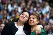 Audience members react as President Barack Obama delivers remarks