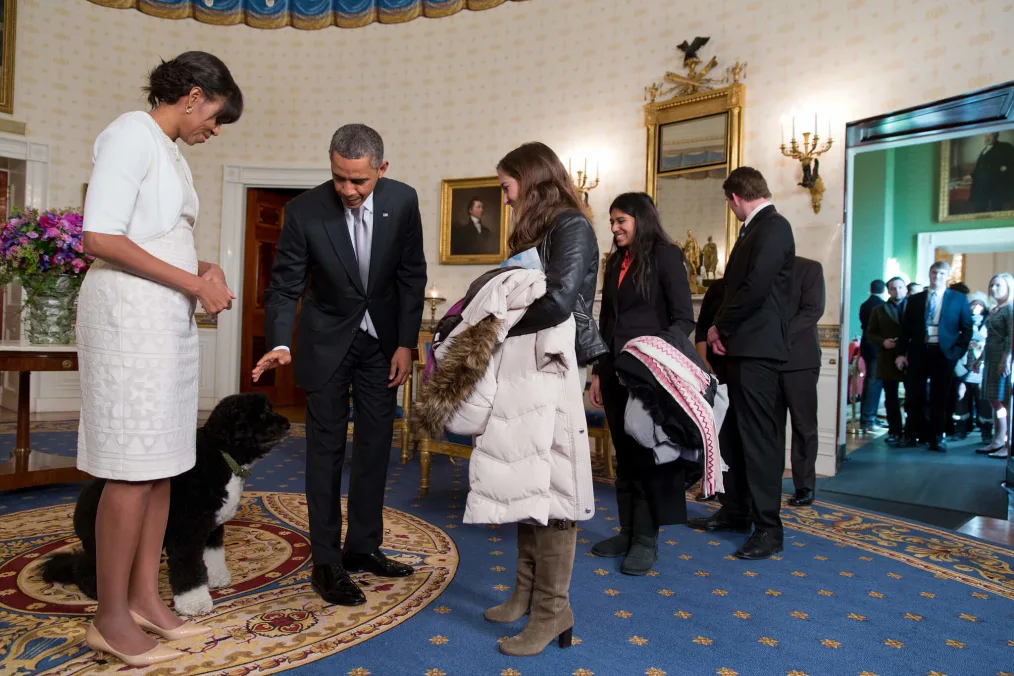 President Barack Obama, First Lady Michelle Obama, and Bo, the Obama family dog, greet visitors