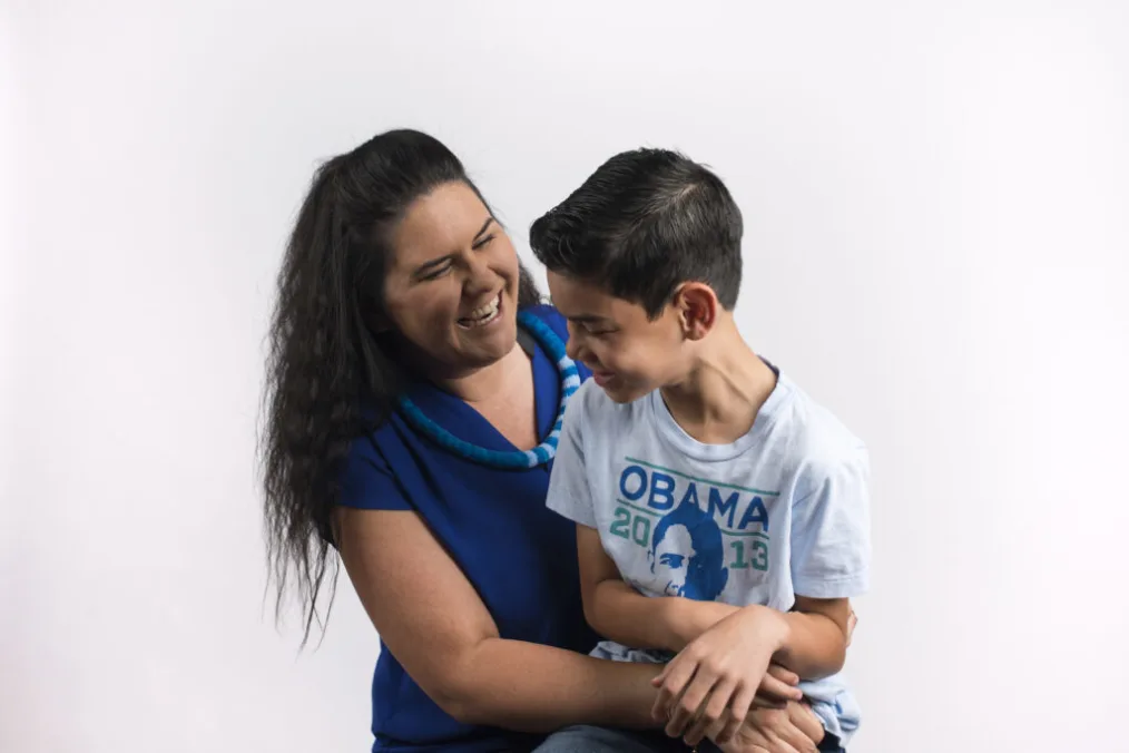 Kealoha Fox laughs and holds her son.