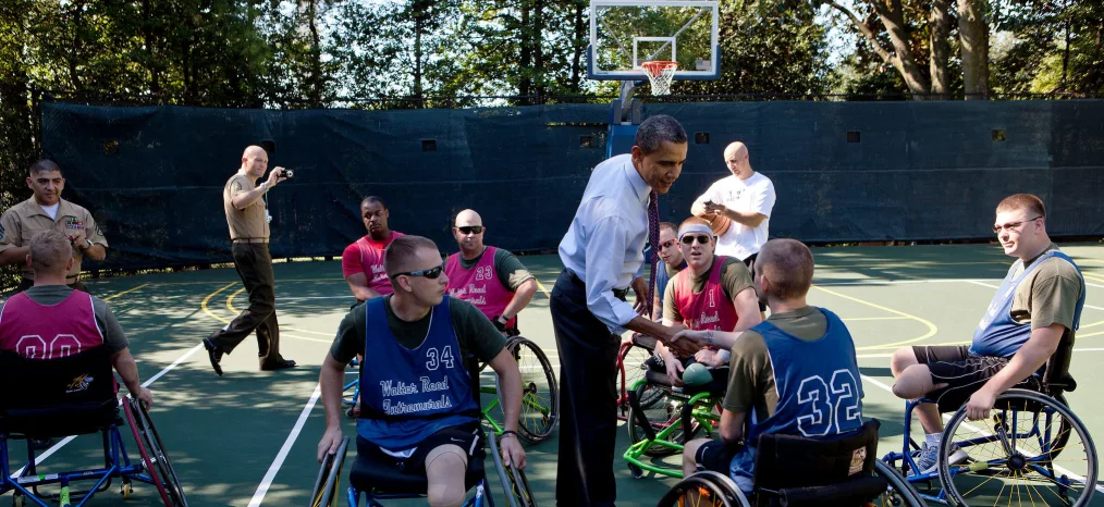 President Barack Obama greets players during a Wounded Warrior basketball game