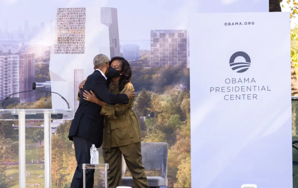 President Obama hugs former First Lady Michelle Obama at the groundbreaking event for the Obama Presidential Center.