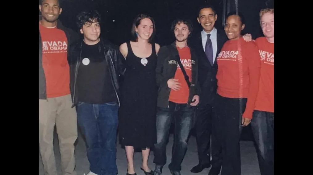 This picture shows President Obama posing and smiling with a group of people with various skin tones.