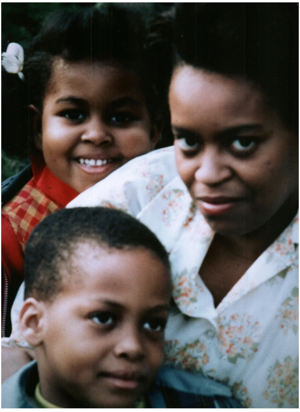 Marian Robinson poses for a photo with her children, a young Michelle Obama and Craig Robinson.