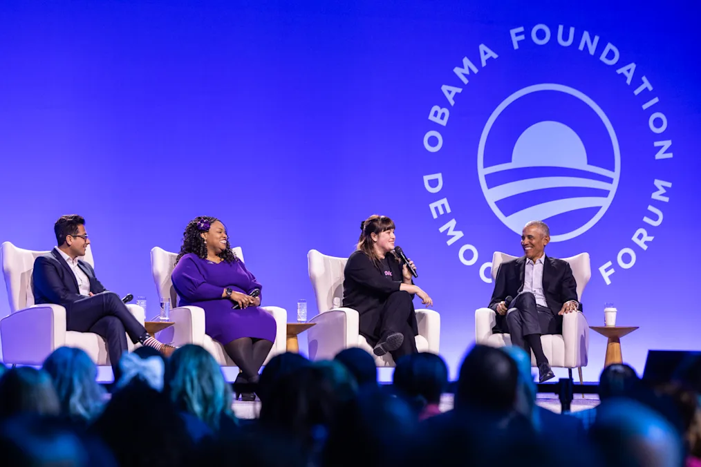 President Barack Obama moderates "Hope and Pluralism," a conversation with next-generation leaders Manu Meel, Nika Kovač, and Ainka Jackson. All are a range of light to dark skin tones. 