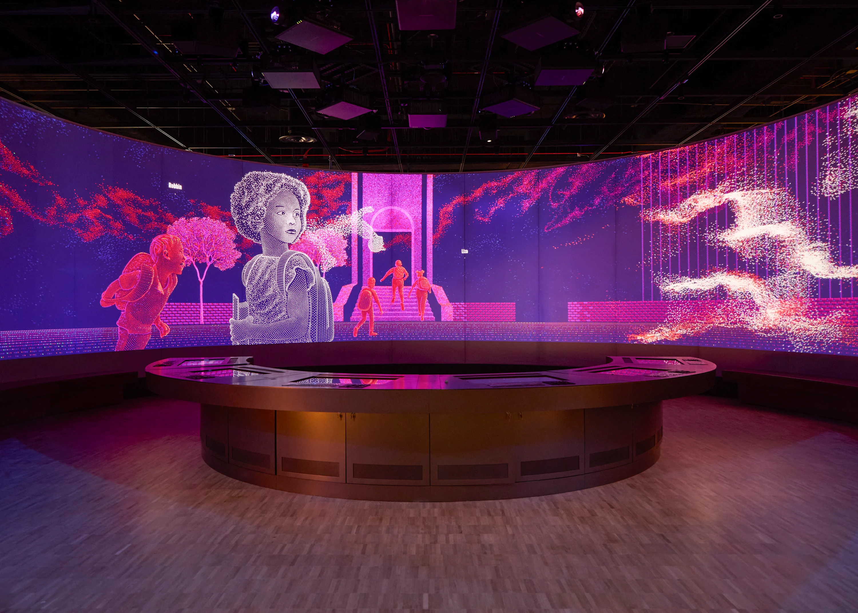 An image of one of the digital screens in the “We The People” exhibit. The image is dotted with bright hues of pink and purple. There is an illustrated woman in the forefront of the picture, looking off into the distance. In the background of the screen are several faceless people walking into a building Below the screen is an interactive panel for visitors to the Museum to use. 