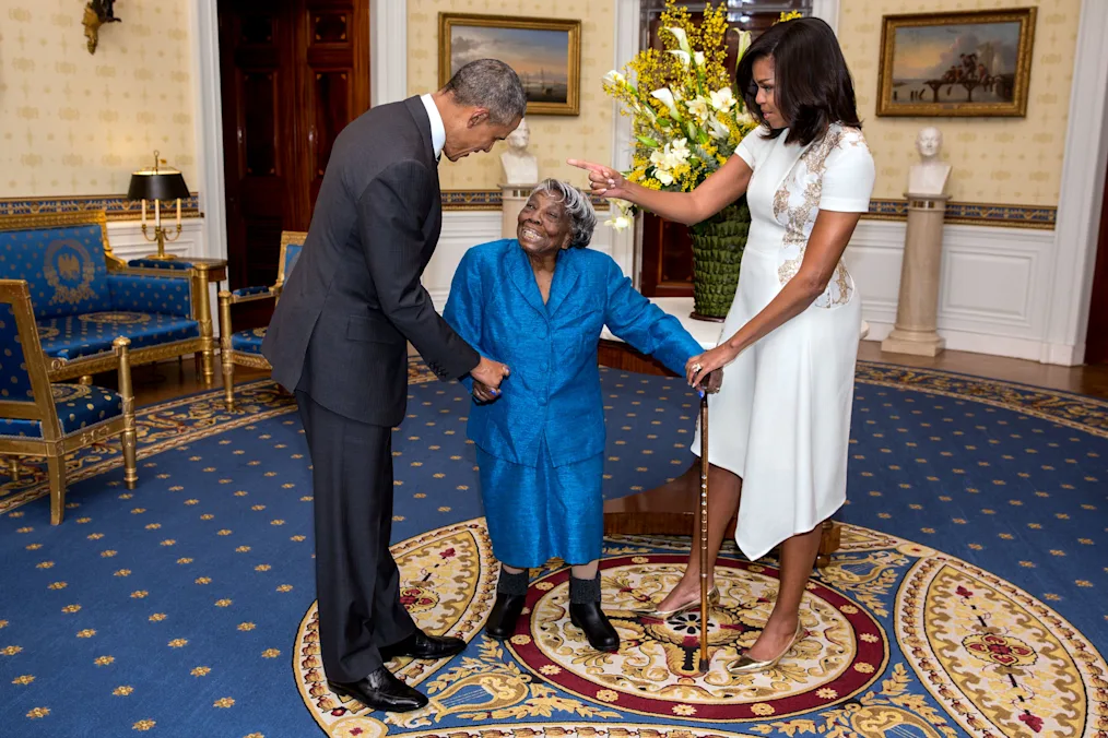 President Barack Obama and First Lady Michelle Obama greet 106-year-old Virginia McLaurin during a photo line in the Blue Room of the White House prior to a reception celebrating African American History Month.