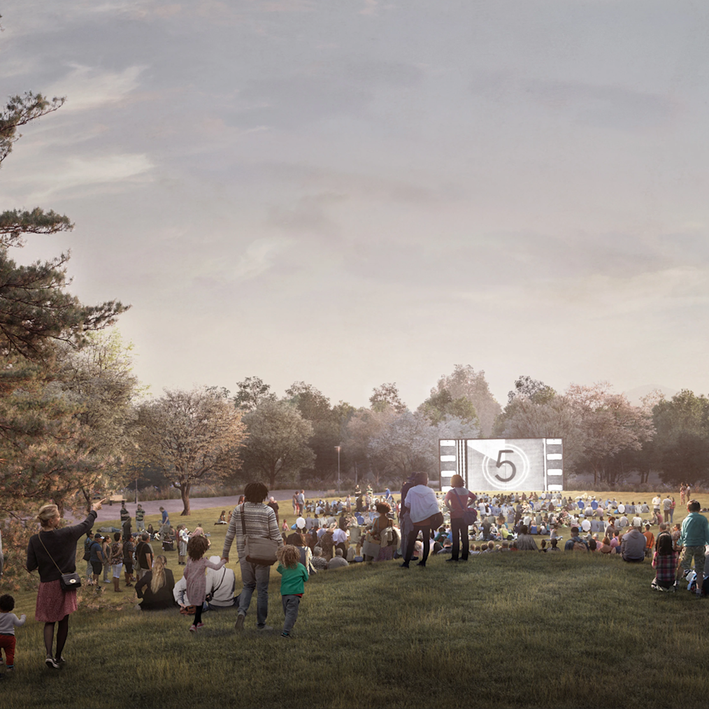 A rendering of a movie being shown on the Great Lawn at the Obama Presidential Center. Hundreds of people of all ages and skin tones gather and sit on the grass. 