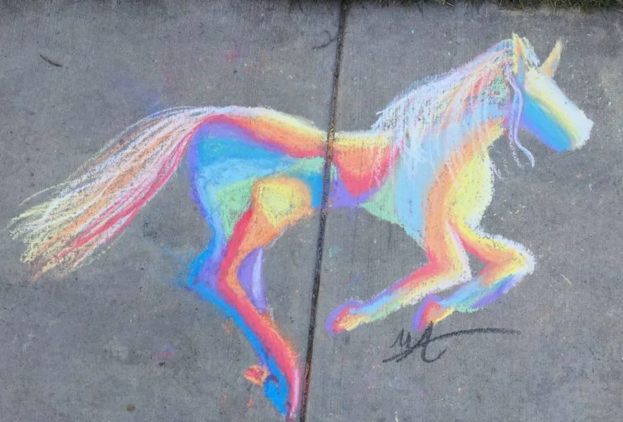 A chalk painting of a horse on a sidewalk.