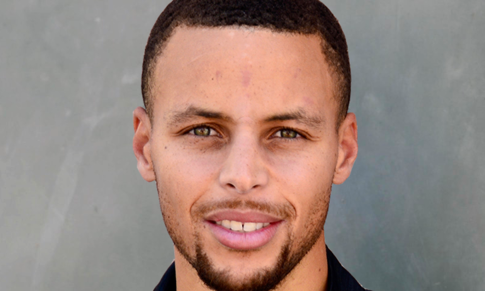This portrait features Stephen Curry, a black man with a medium skin tone, beard, hazel eyes, and low hair cut smiling. 