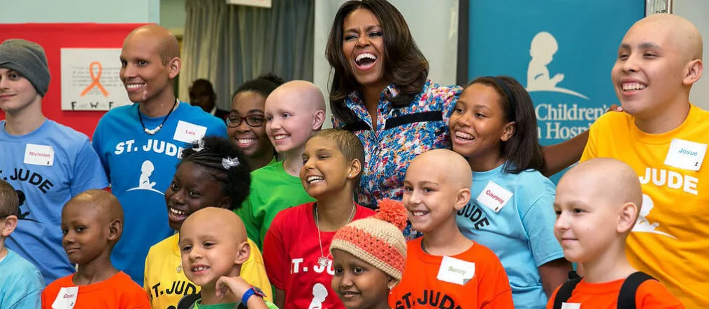 First Lady Michelle Obama joins children for a group photo