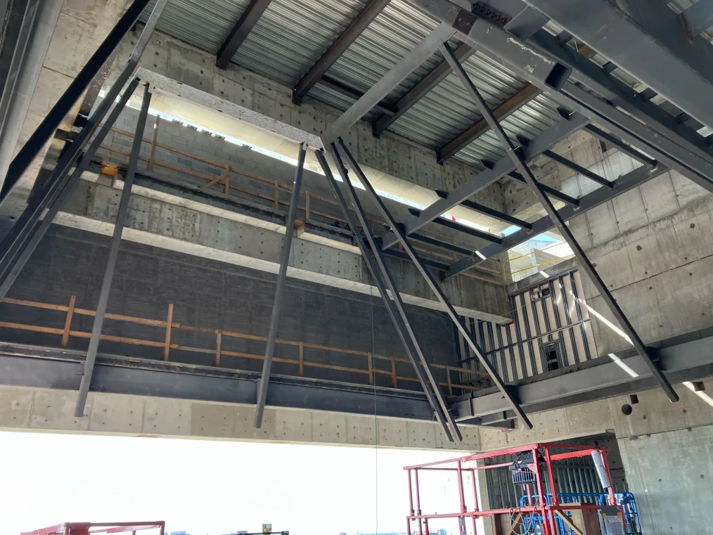 A steel structure of the Sky Room cone ceiling at the Museum Building at the Obama Presidential Center. Construction equipment is at the bottom of the frame.