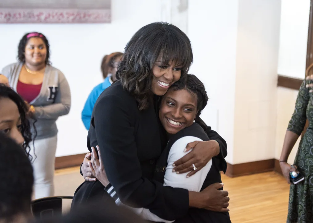 Michelle Obama hugging someone.