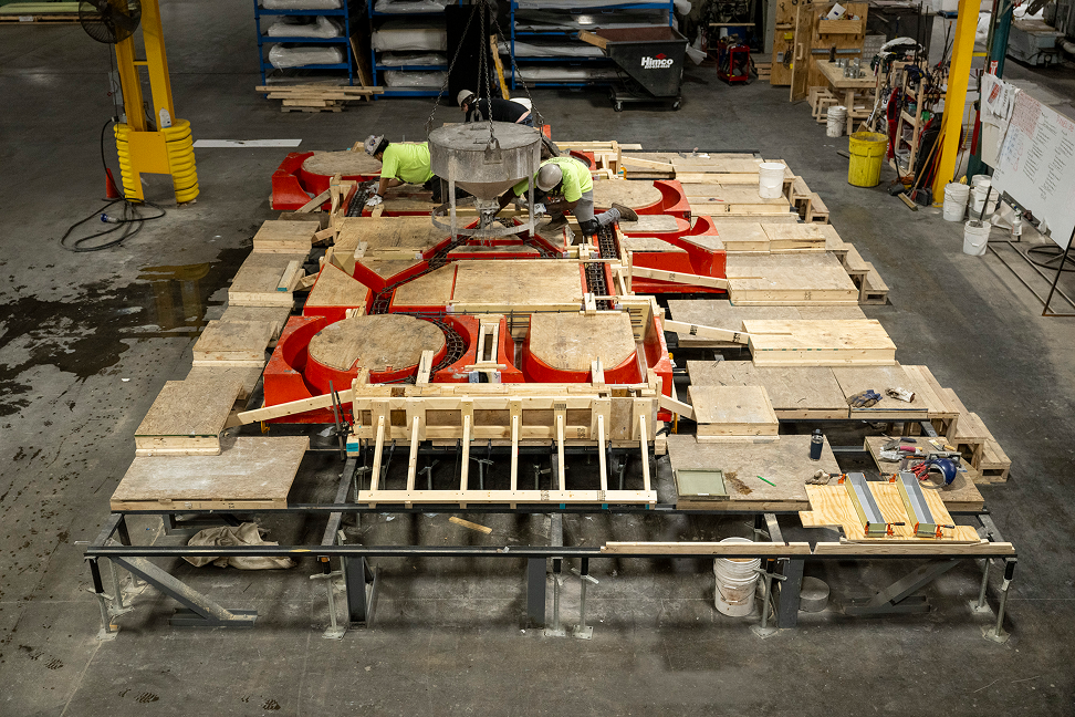 Concrete is poured into molds used in the construction of the “You Are America” letters to be installed on the side of the Obama Presidential Center Museum at Shaffner Heaney .
