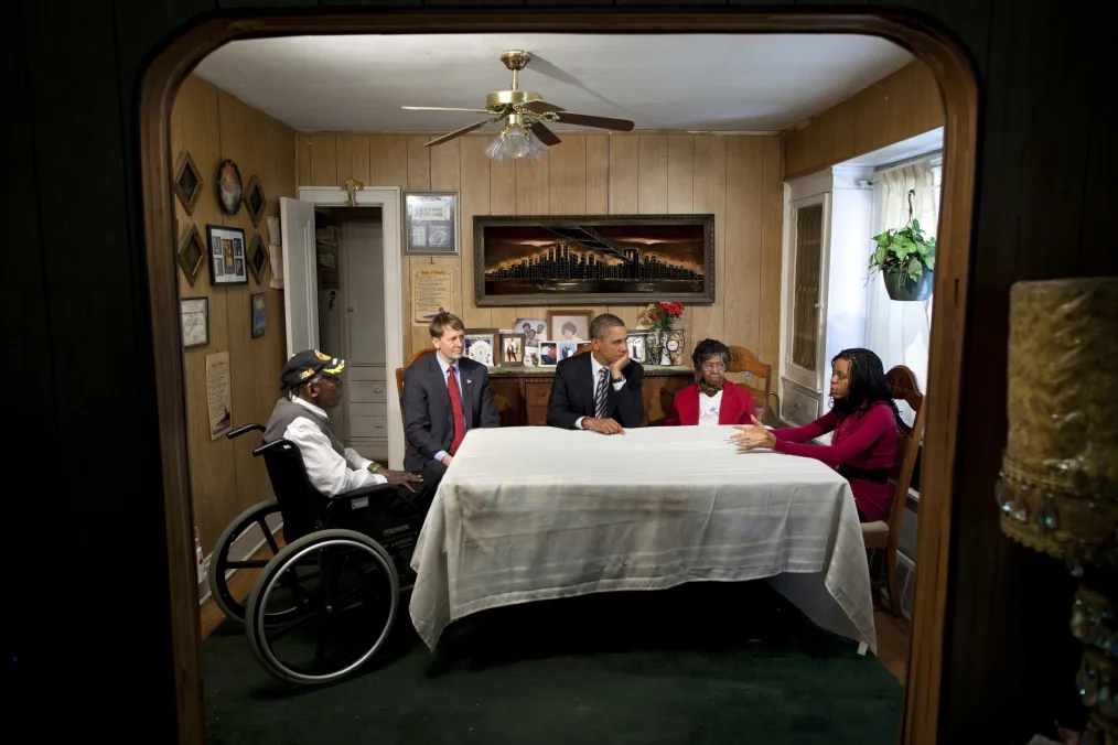 President Obama and Richard Cordary,director of the Consumer Finacal Protection Bureau talks with a family in their home