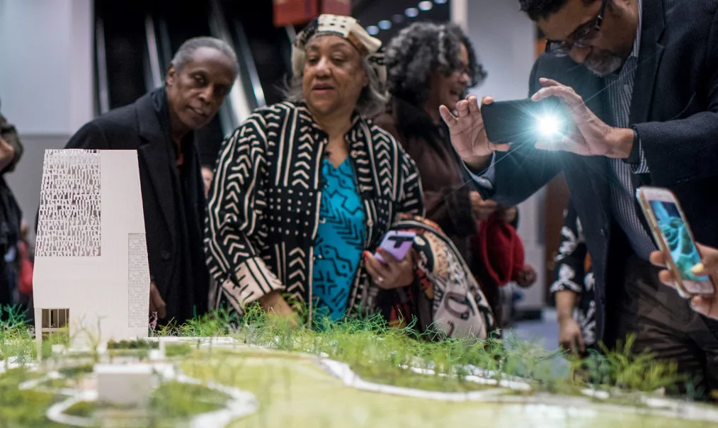 Attendees look at a model of the Obama Presidential Center (OPC) at a public meeting to discuss the OPC in Chicago, IL