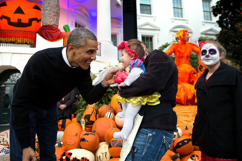President Barack Obama hands treats out to local children and children of military families