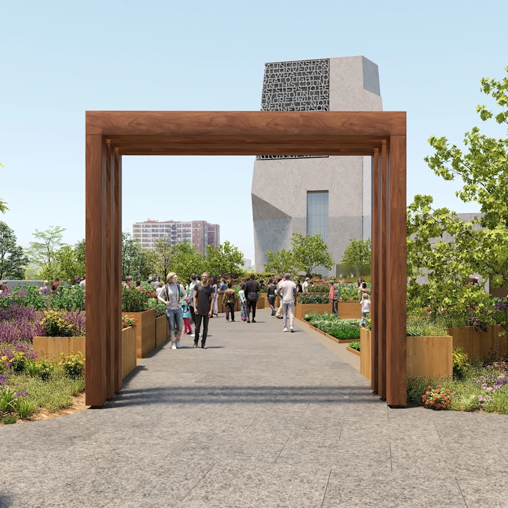 A rendering of the entrance to the Fruit and Vegetable Garden at the Obama Presidential Center. People are shown walking toward the Museum Building in the background. It is a sunny day. 